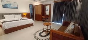 a bedroom with a bed and a chair in it at Artha Sadia Villa 2 Seseh Beach in Cemagi +71 photos