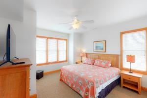 a bedroom with a bed and a flat screen tv at BXOLRD2 Native Sun #9-BB in Buxton +29 photos