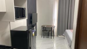 a room with a television and a table and a stool at Gem's Silid Tulugan in Cebu City