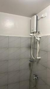 a shower with a shower head in a bathroom at Gem's Silid Tulugan in Cebu City +6 photos