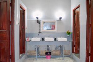 a bathroom with two sinks and two mirrors at Aroma Hostel in Vientiane +34 photos