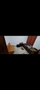 two pictures of a room with a table and a floor at Alquileres BH in La Rioja