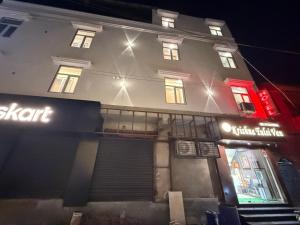 a building with a sign in front of it at night at Hotel Krishna Tulsi Van - Near Bankey Bihari & ISKCON in Vrindāvan