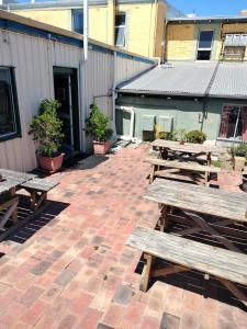 a group of picnic tables on a brick patio at Albany Bayview Lodge in Albany