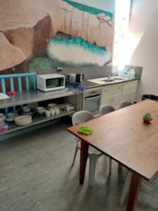 a kitchen with a table and a counter with a microwave at Albany Bayview Lodge in Albany
