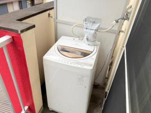 a washer and dryer with a machine on top of it at サクセスハイム 203 in Miyazaki