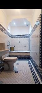 a bathroom with a toilet and a sink at Riad Benkirane Fes Medina in Fez
