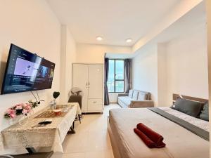 a hotel room with a large bed and a tv at Stay With Me CBD Apartment - Rivergate Building in Ho Chi Minh City
