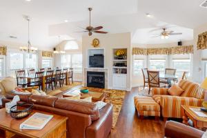 a living room with leather furniture and a fireplace at SOSB26 South Beach Park #26-S in Salvo