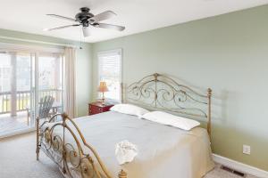 a bedroom with a bed with a ceiling fan at SOSB26 South Beach Park #26-S in Salvo +40 photos