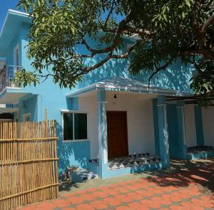 a blue and white house with a red door at Irida 2bhk private pool viila in Assagao