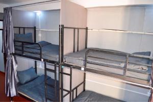 two bunk beds in a room with blue pillows at Aroma Hostel in Vientiane