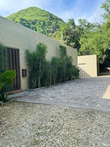 a building with a bunch of trees in front of it at Juntas del Lago - Casa 3 in Apulo
