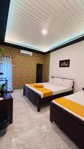 a room with two beds in a room at Sandakada Homestay in Anuradhapura