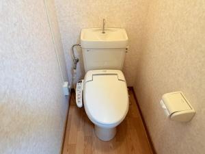 a bathroom with a white toilet with a sink at サクセスハイム 208 in Miyazaki