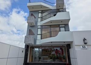 a tall white building with a store window at Huỳnh Nga Măng Đen Hotel in Kon Plong