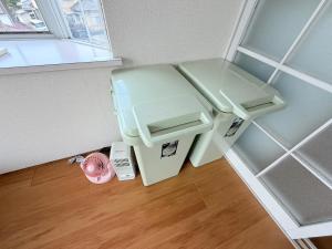 a trash can sitting in the corner of a room at テラスリバーサイド 301 in Miyazaki