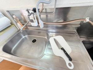 a kitchen sink with a spatula next to it at テラスリバーサイド 301 in Miyazaki +23 photos