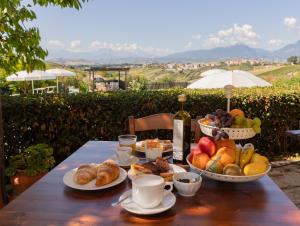 a table with plates of food and a bottle of wine at Agriturismo Villa Fiore in Torano Nuovo