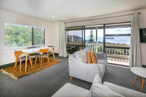 a living room with a couch and a table at Hahei Island Views in Hahei +15 photos