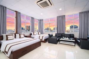 a hotel room with two beds and a couch at Diamond Luxury Ben Thanh in Ho Chi Minh City +87 photos