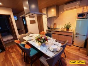 a kitchen and dining room with a table and chairs at Sankando Villa Hotel in Fujikawaguchiko