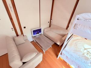 an overhead view of a room with a bed and a laptop at パームハウス 202 in Miyazaki