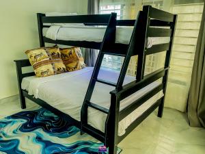 a bedroom with two bunk beds in a room at Casuarina Apartments in Livingstone