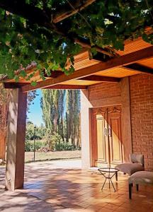 an open door to a house with a patio at Barreal La Templanza Casa de Campo in Barreal