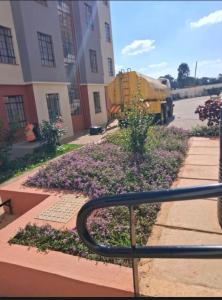 a bed of purple flowers in front of a building at BoniMark in Machakos