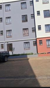 a truck parked in front of a tall building at BoniMark in Machakos