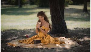 a woman in a yellow dress sitting on a blanket at La Belle et le Nooki in Meaux