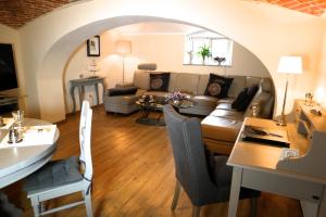 a living room with a couch and a table at Villa Le Palais Quedlinburg in Quedlinburg