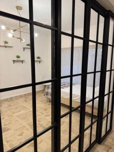 a view through a glass door of a bedroom at Equipped apartment in industrial area in Ciudad Satelite del Norte +6 photos