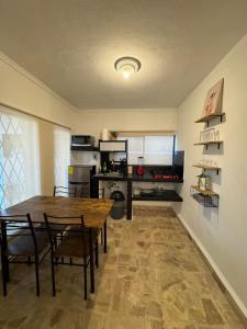 a kitchen and dining room with a table and chairs at Equipped apartment in industrial area in Ciudad Satelite del Norte