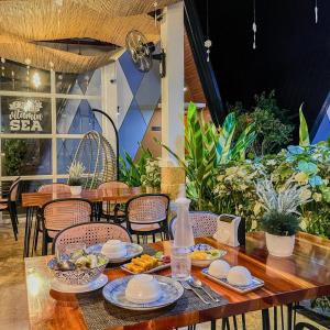 a wooden table with plates of food on it at Solsticio Azzul Beach Resort in Pandan +22 photos