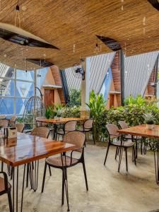 a group of tables and chairs in a restaurant at Solsticio Azzul Beach Resort in Pandan