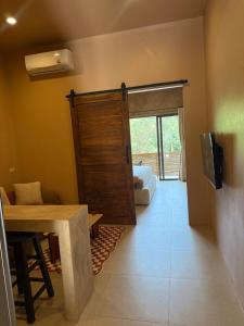 a room with a door leading to a bedroom at The Petra Boutique Studios in Ko Tao