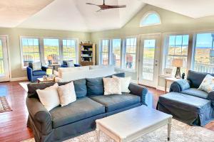a living room with a couch and chairs and windows at FO13 Dreamcatcher in Frisco