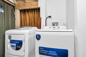 a bathroom with two water heaters and a sink at Newly Renovated 2BR Basement Suite, Private Entry in Pickering
