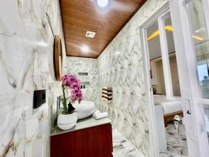 a bathroom with a sink and a mirror at Agustik Villas in Badung
