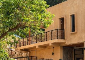 a building with a balcony on the side of it at The Petra Boutique Studios in Ko Tao