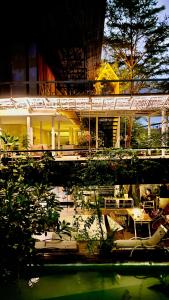 a building with tables and chairs in front of it at The Hide Hostel Canggu in Canggu