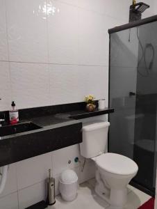 a bathroom with a white toilet and a sink at Mirian nascimento in Camaçari +4 photos