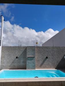 a swimming pool on top of a brick building at Mirian nascimento in Camaçari