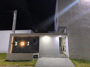 a building with a garage door at night at Mirian nascimento in Camaçari
