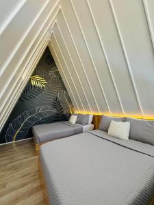 a room with two beds and a wall with plants at Solsticio Azzul Beach Resort in Pandan