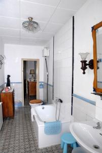 a bathroom with a tub and a toilet and a sink at Ca la Paula in Pla del Panadés