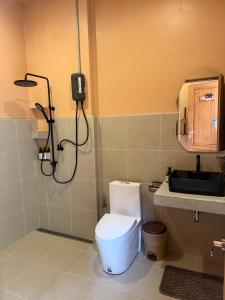 a bathroom with a toilet and a phone on the wall at The Petra Boutique Studios in Ko Tao +15 photos