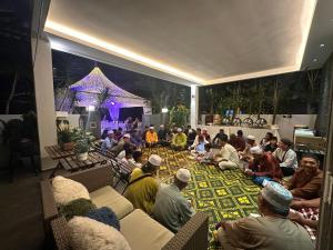 a group of people sitting on the floor in a room at The Lumber with Private Pool in Masjid Tanah +38 photos